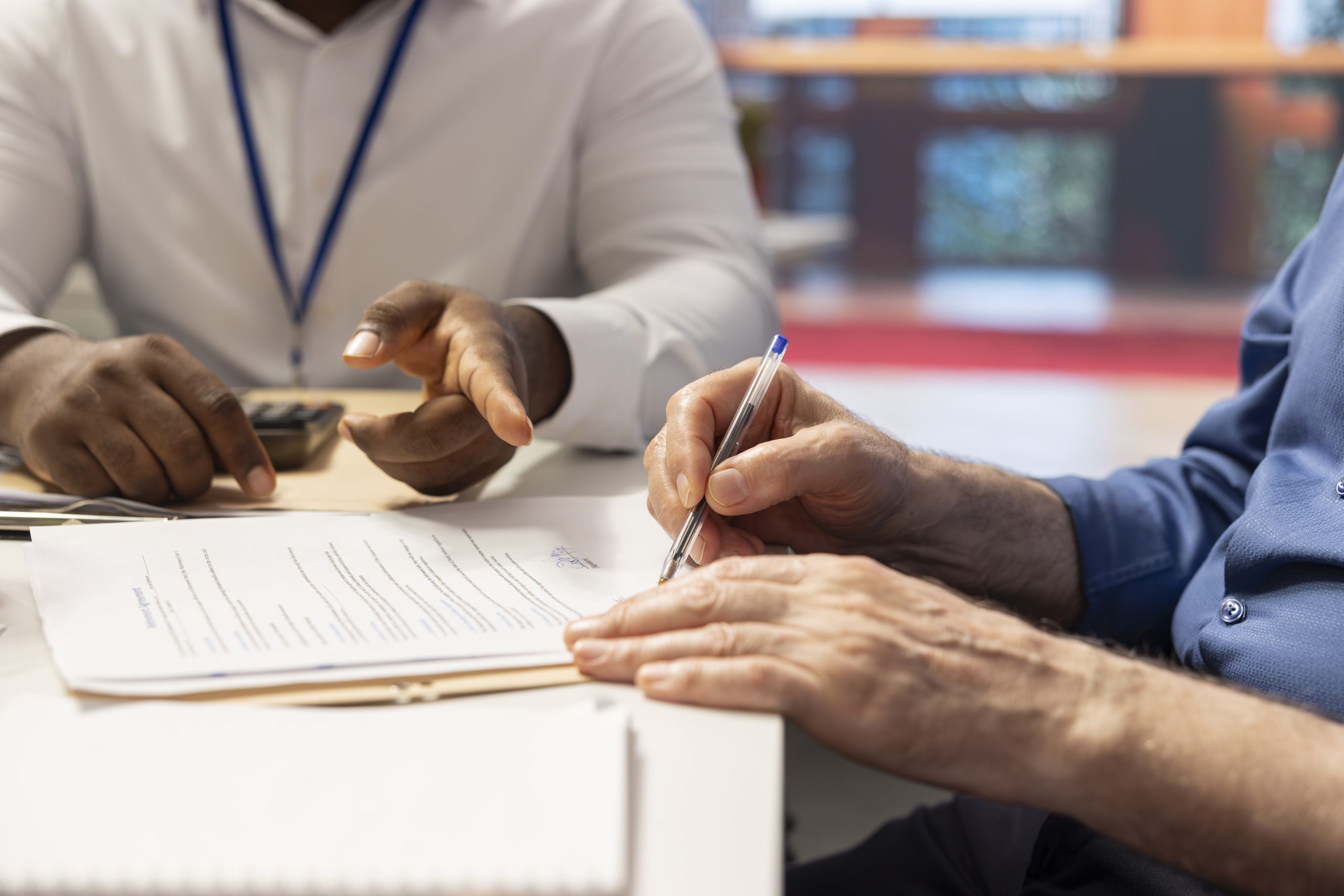 Mature person signing pension plan contract retirement package scaled